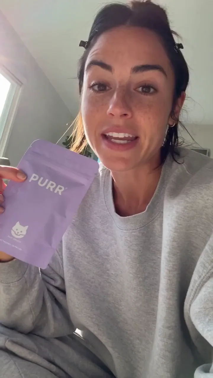 A creator tries to review cat treats and her cat takes over the shot